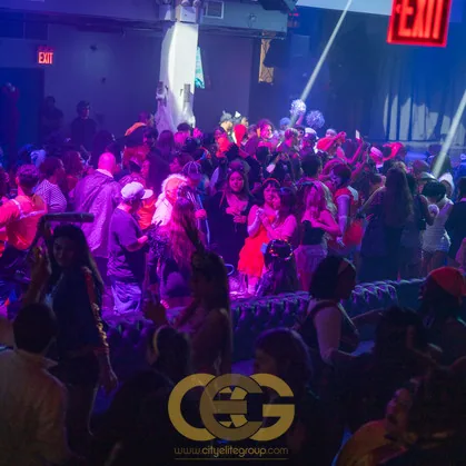 Crowd dancing under vivid club lighting at a past Fright Night